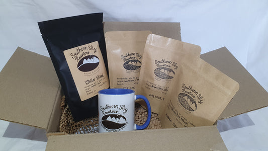 A coffee gift box opened to reveal a 250g bag of organic coffee beans and three smaller trial-size bags of 100g of coffee, labelled with different blends, alongside a blue mug with the Southern Sky Roasters logo.
Organic Coffee,
Artisan Roastery
Lake Tekapo, New Zealand
