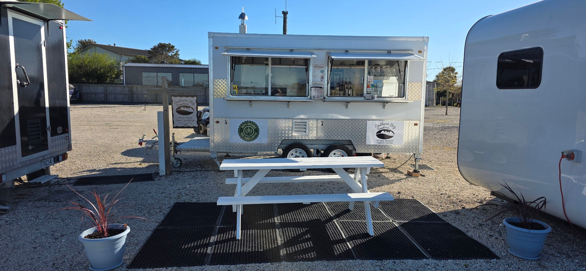Southern Sky Roasters coffee cart with signage at 16 Aranui Road, Māpua, and a picnic table for customers to enjoy their coffee